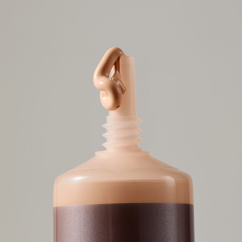 "Macro view of TimeWise Matte 3D Foundation needle-nose applicator dispensing Light 4 shade"