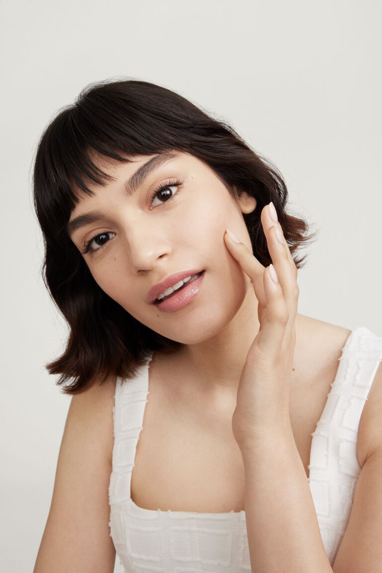 Woman with chin resting on hand wearing Timewise
