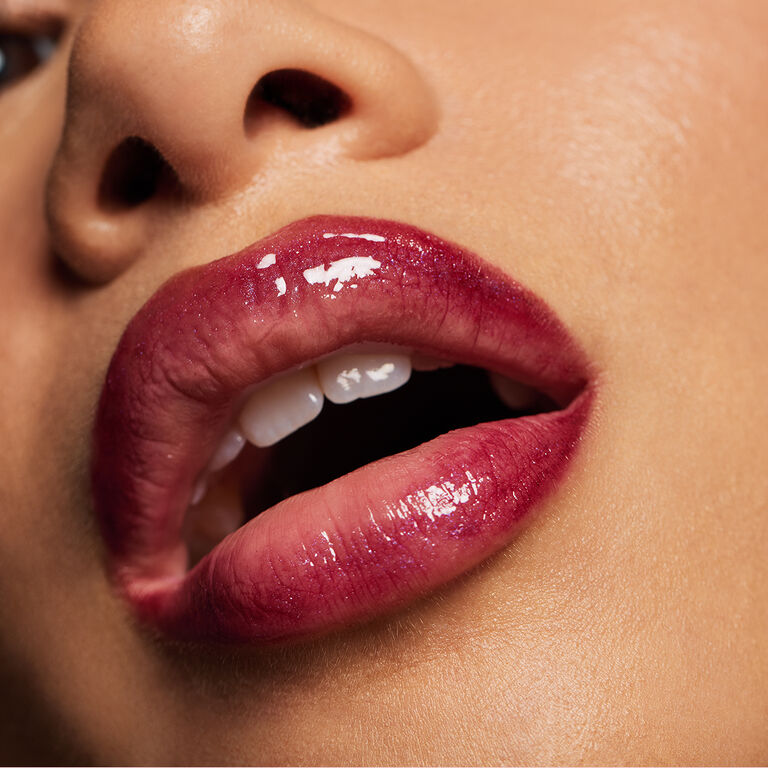 Close-up of glossy, berry-colored lips