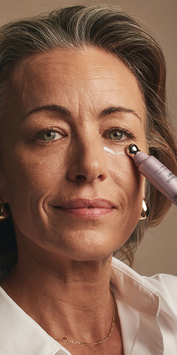 A close up of a woman with cleanser.
