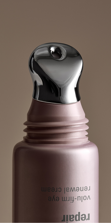 A close up of a woman's face with eye cream.