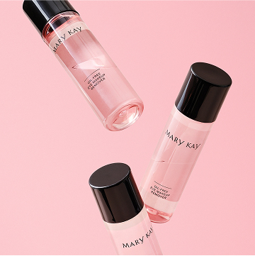 Mary Kay Oil Free Eye Makeup Remover bottles floating on a pink background